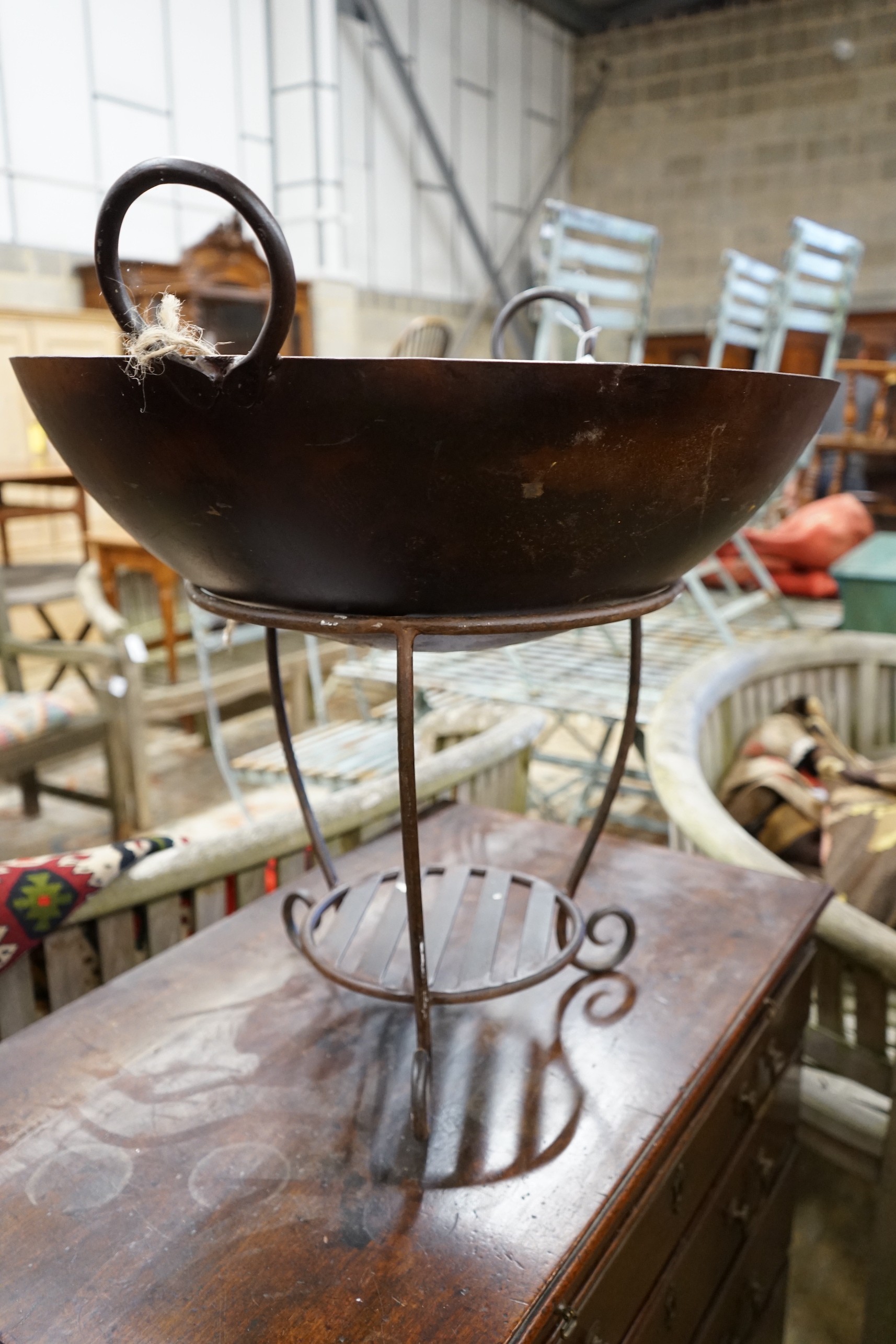 A circular wrought iron fire pit, diameter 61cm, height 59cm